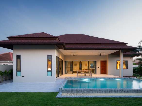 Modern house with pool at sunset