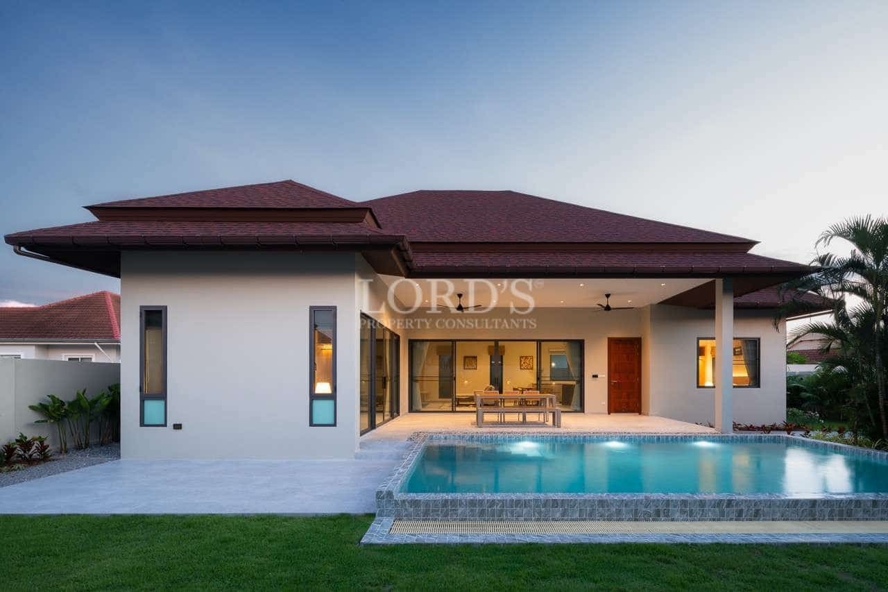 Modern house with pool at sunset