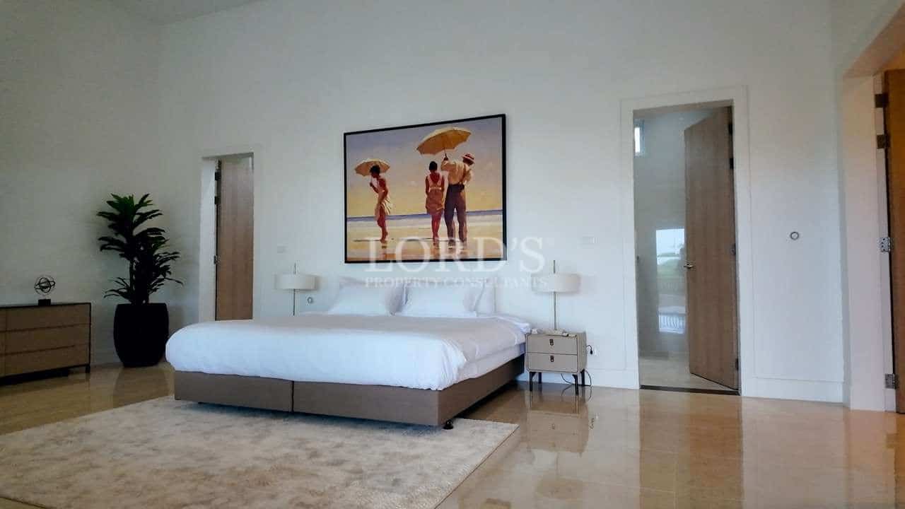 Modern luxury bedroom with king-size bed, minimalist decor, and polished marble flooring.