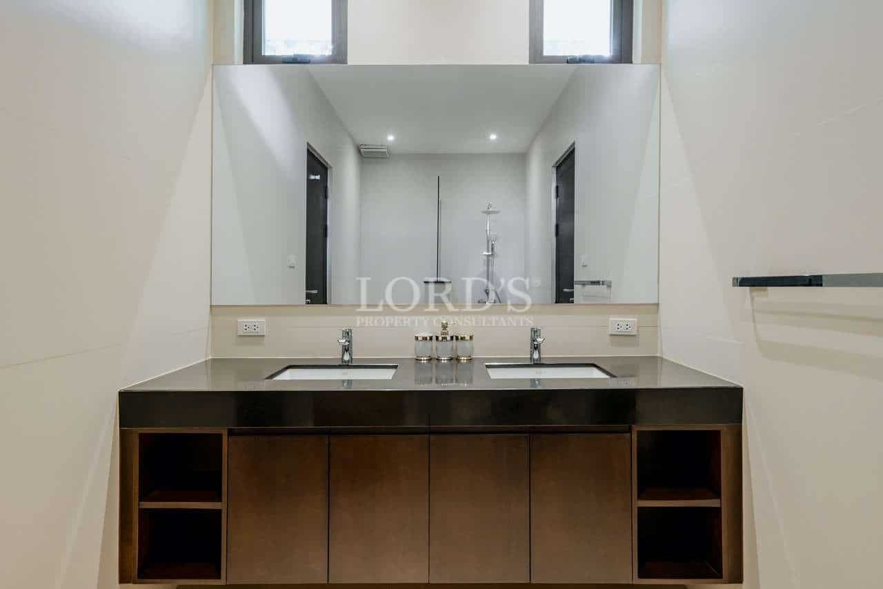 Modern bathroom with dual sinks.
