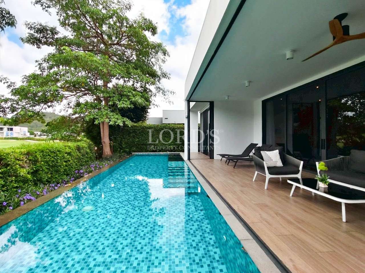 Modern poolside with lush greenery