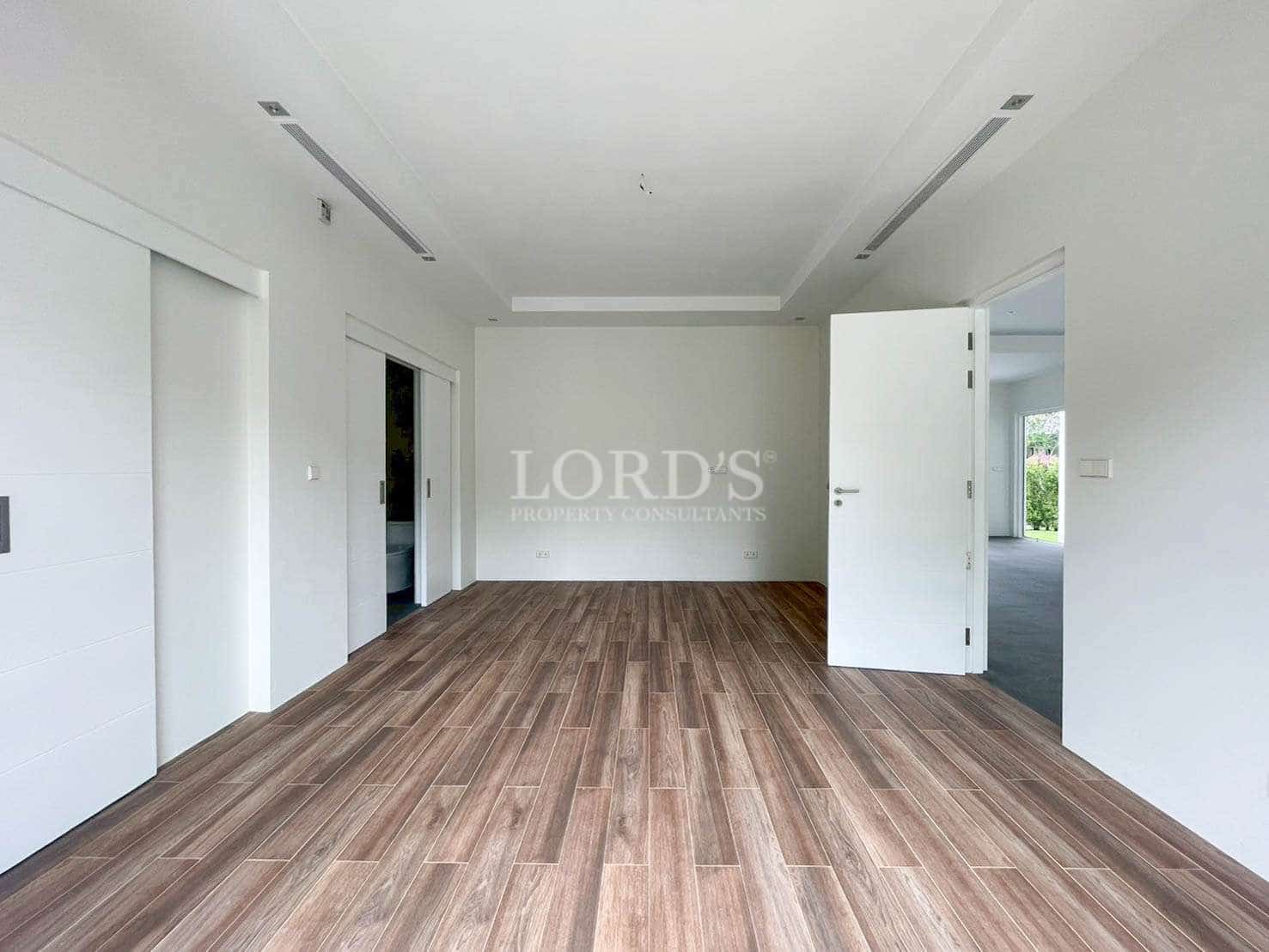 Empty room with wooden flooring.