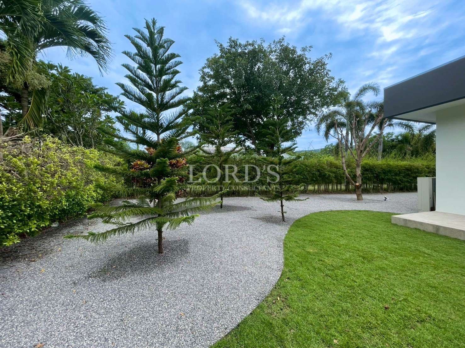 Lush garden with gravel pathway.