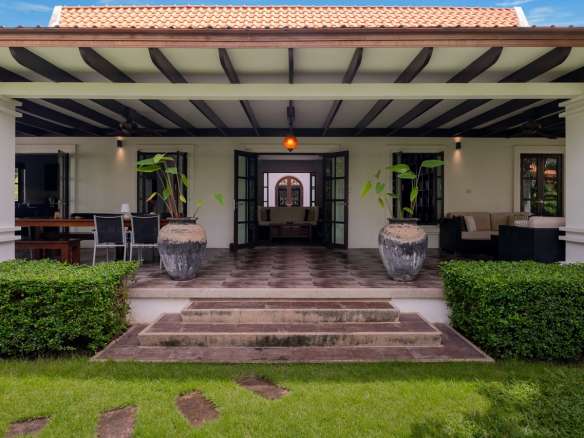 Elegant patio with lush greenery.
