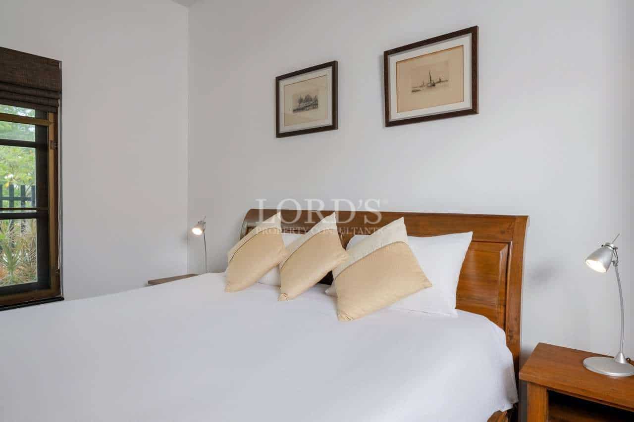 Cozy bedroom with decorative pillows.