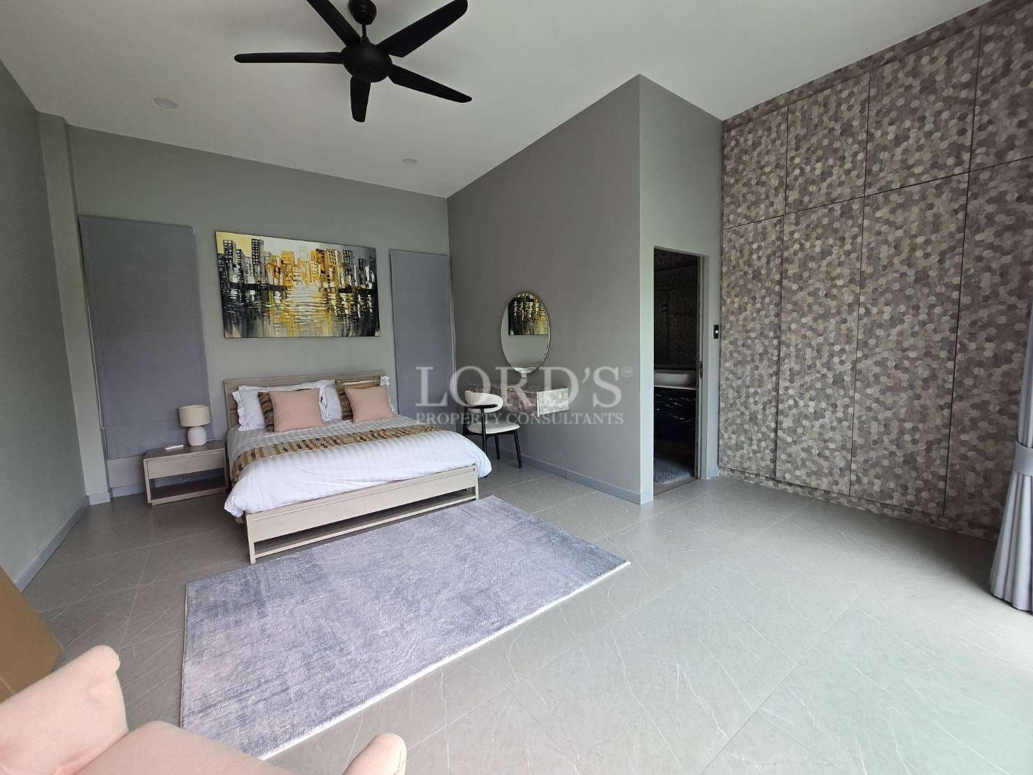 Spacious modern bedroom with king-size bed, patterned feature wall, ceiling fan, and ensuite access.
