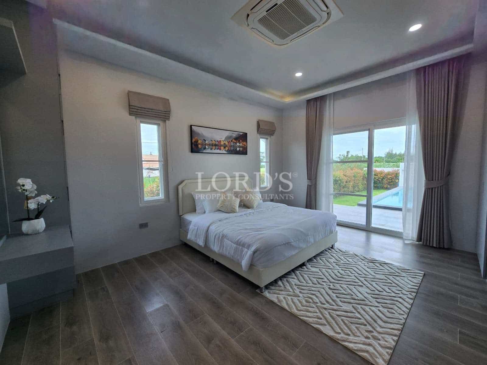 Modern bedroom with large windows