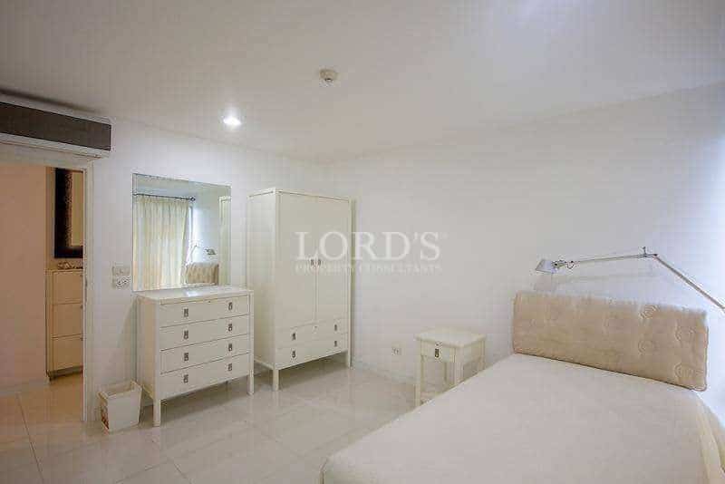 Minimalist bedroom with white furniture