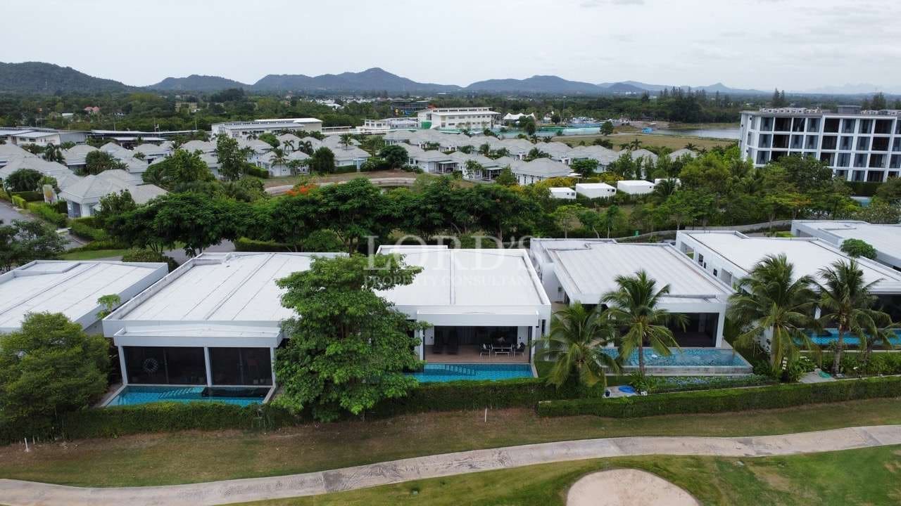 Aerial view of modern villas and greenery.