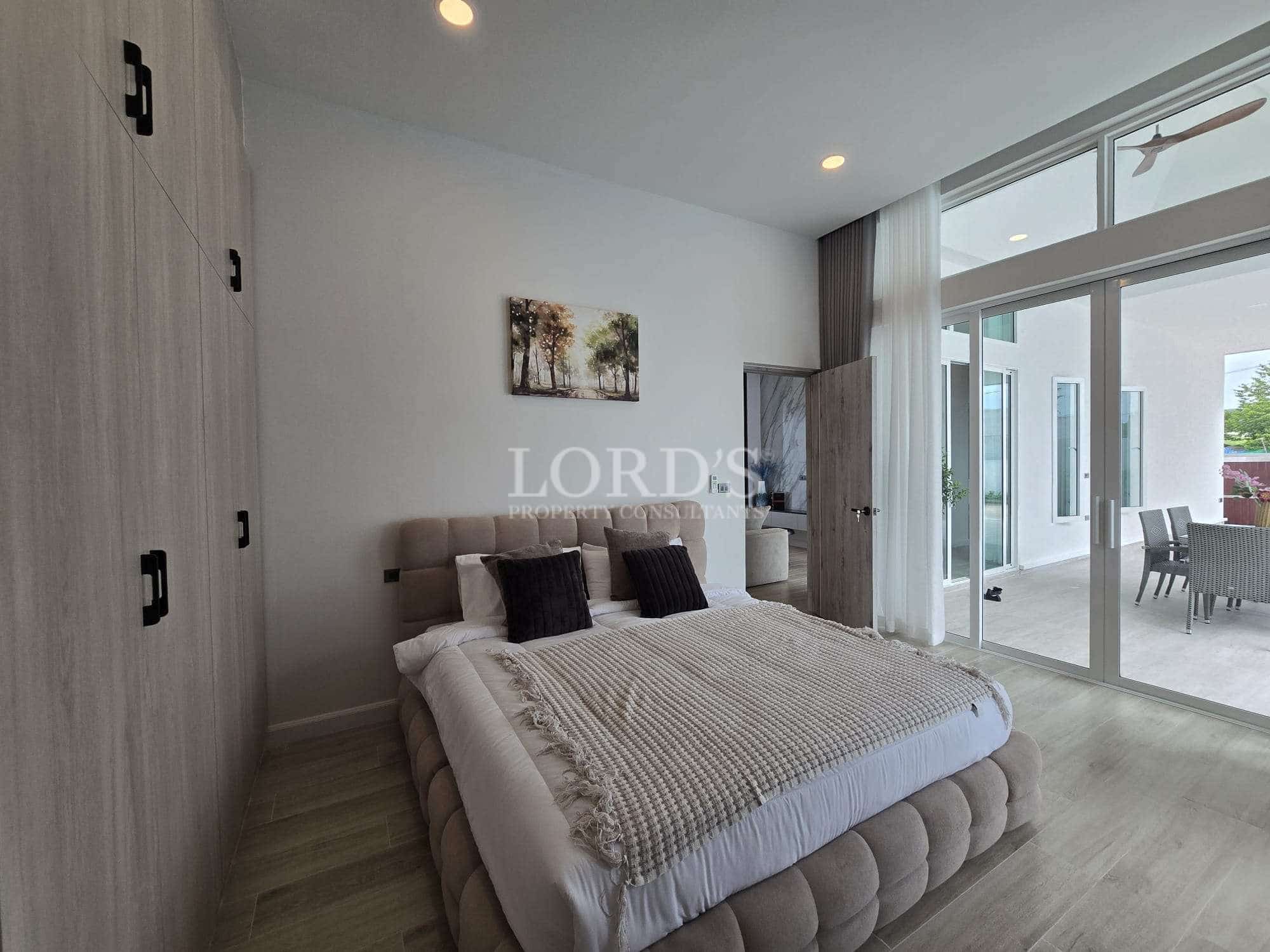 Modern bedroom with large windows