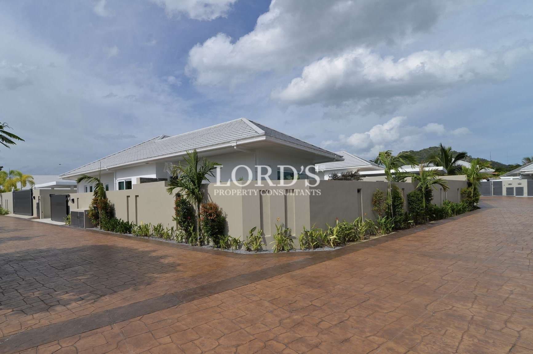 Modern houses with landscaped surroundings.