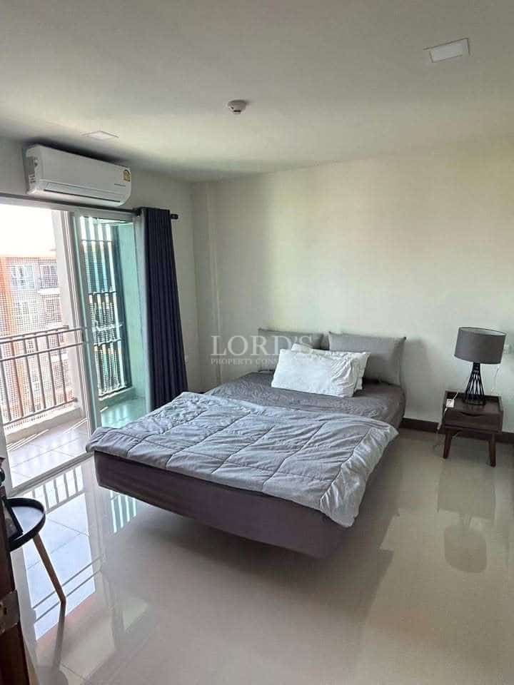 Minimalist bedroom with balcony access