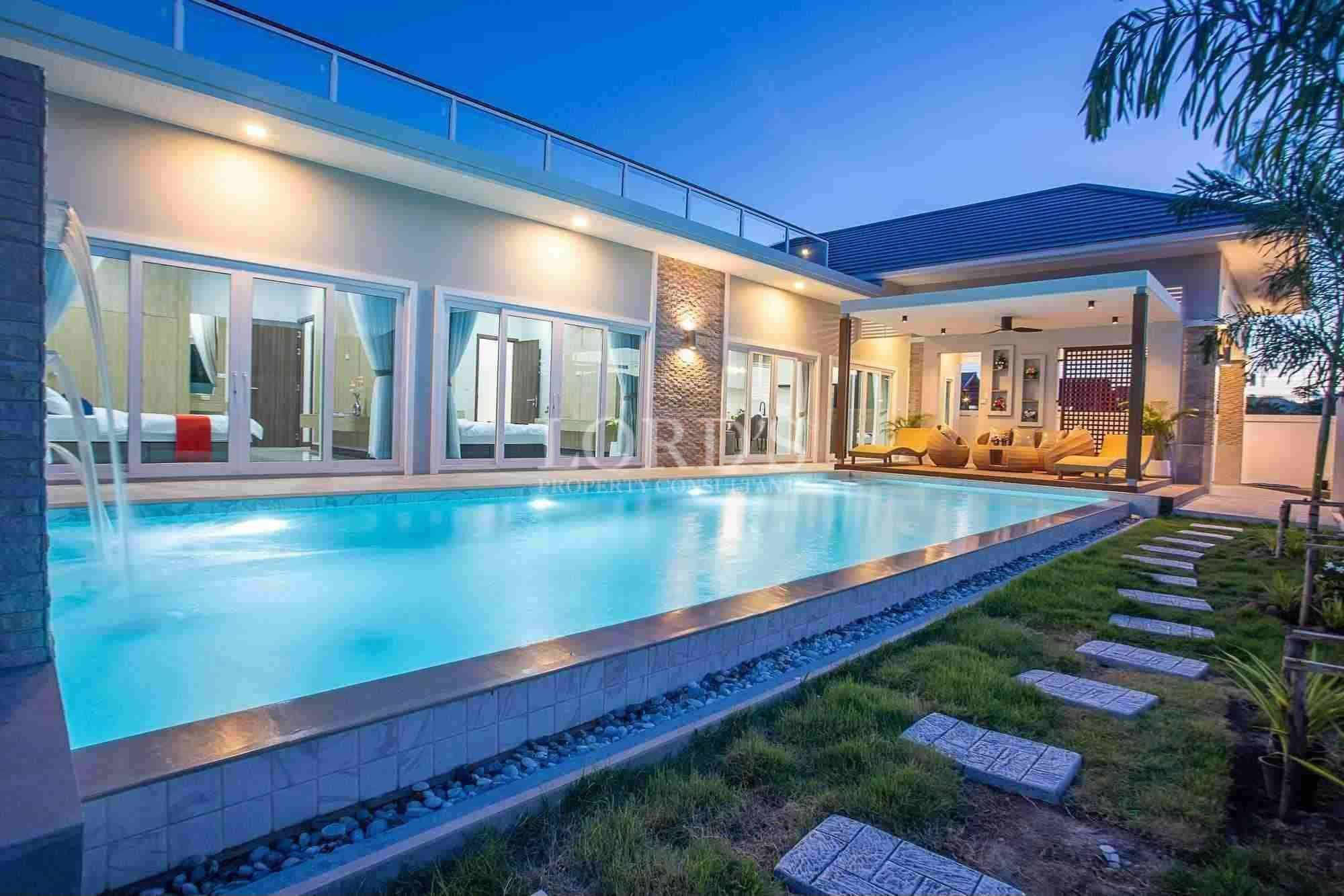 Modern house with pool at dusk