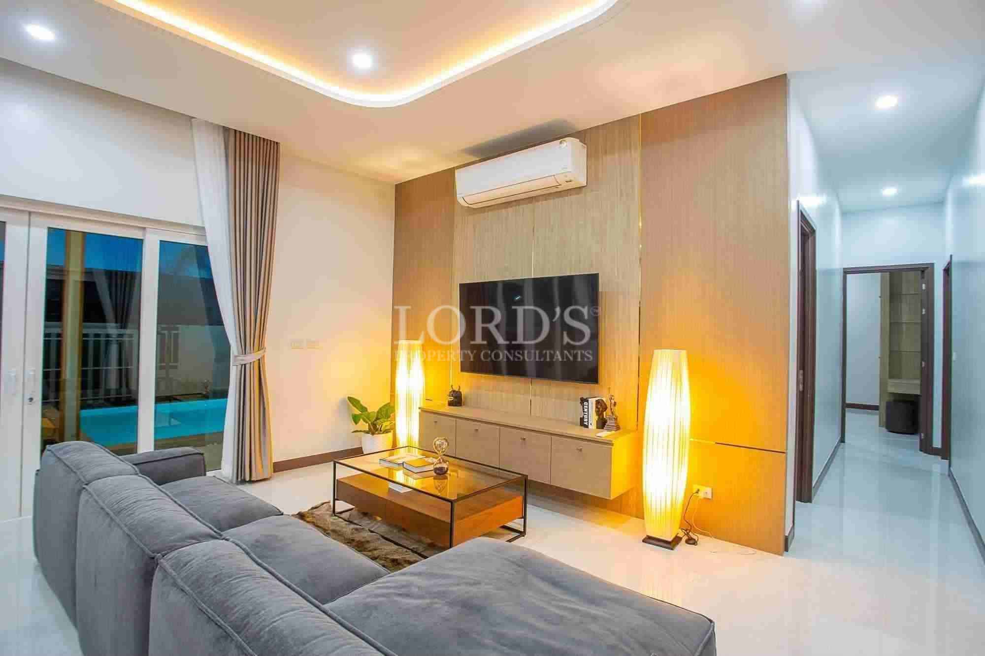 Modern poolside lounge area with greenery