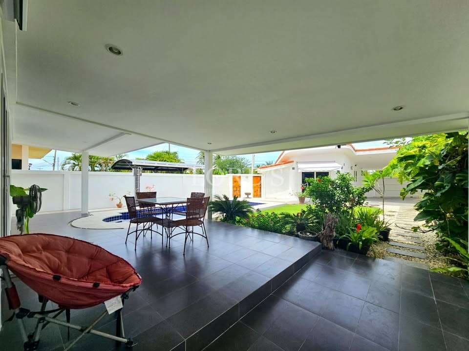 Modern patio with greenery and seating