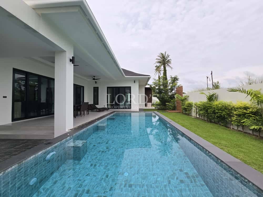 Modern villa with private swimming pool and covered outdoor terrace.