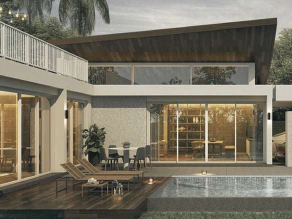 Modern luxury villa exterior with private pool, wooden deck, and large glass doors.