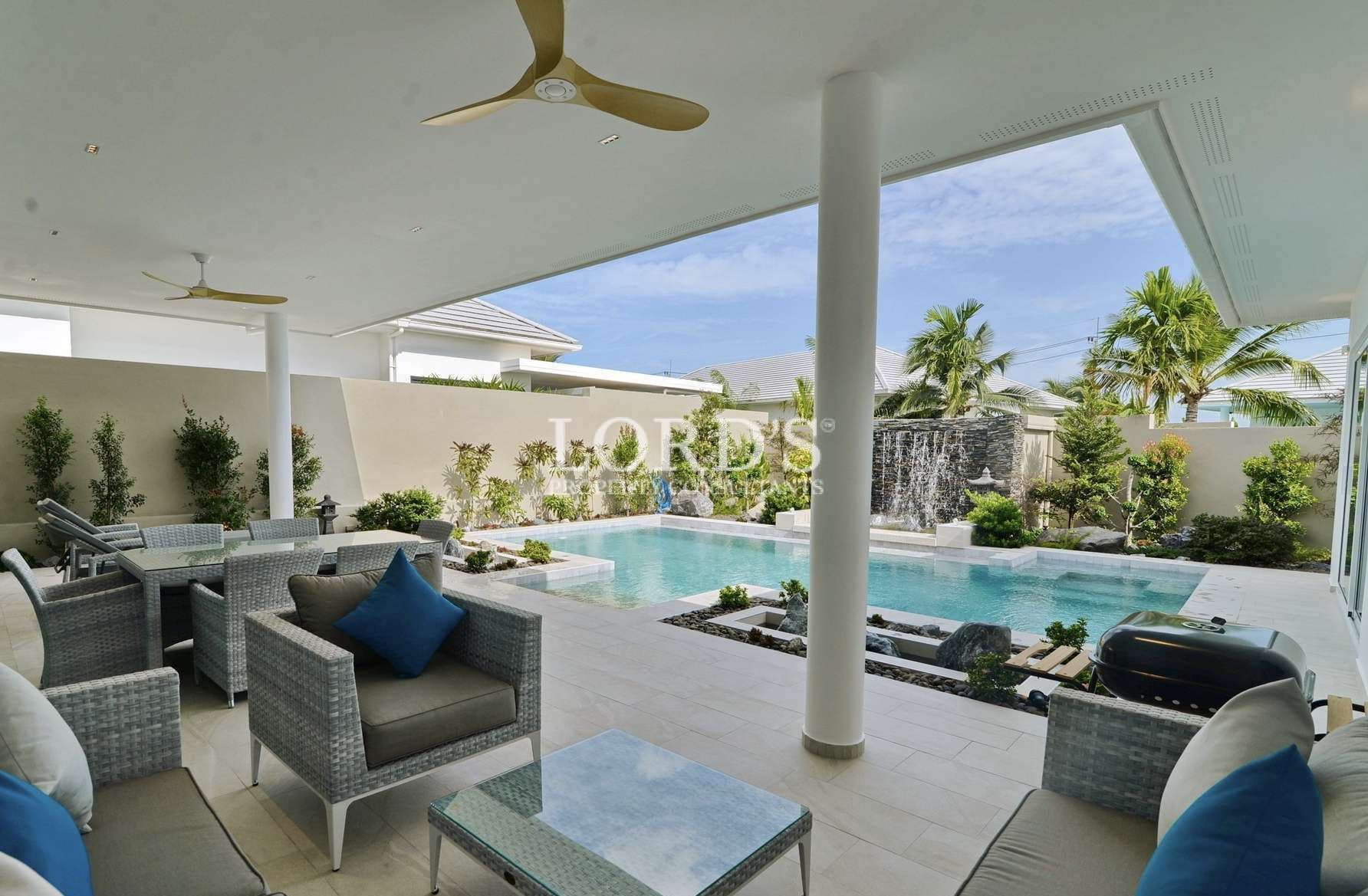 Modern patio with pool and greenery