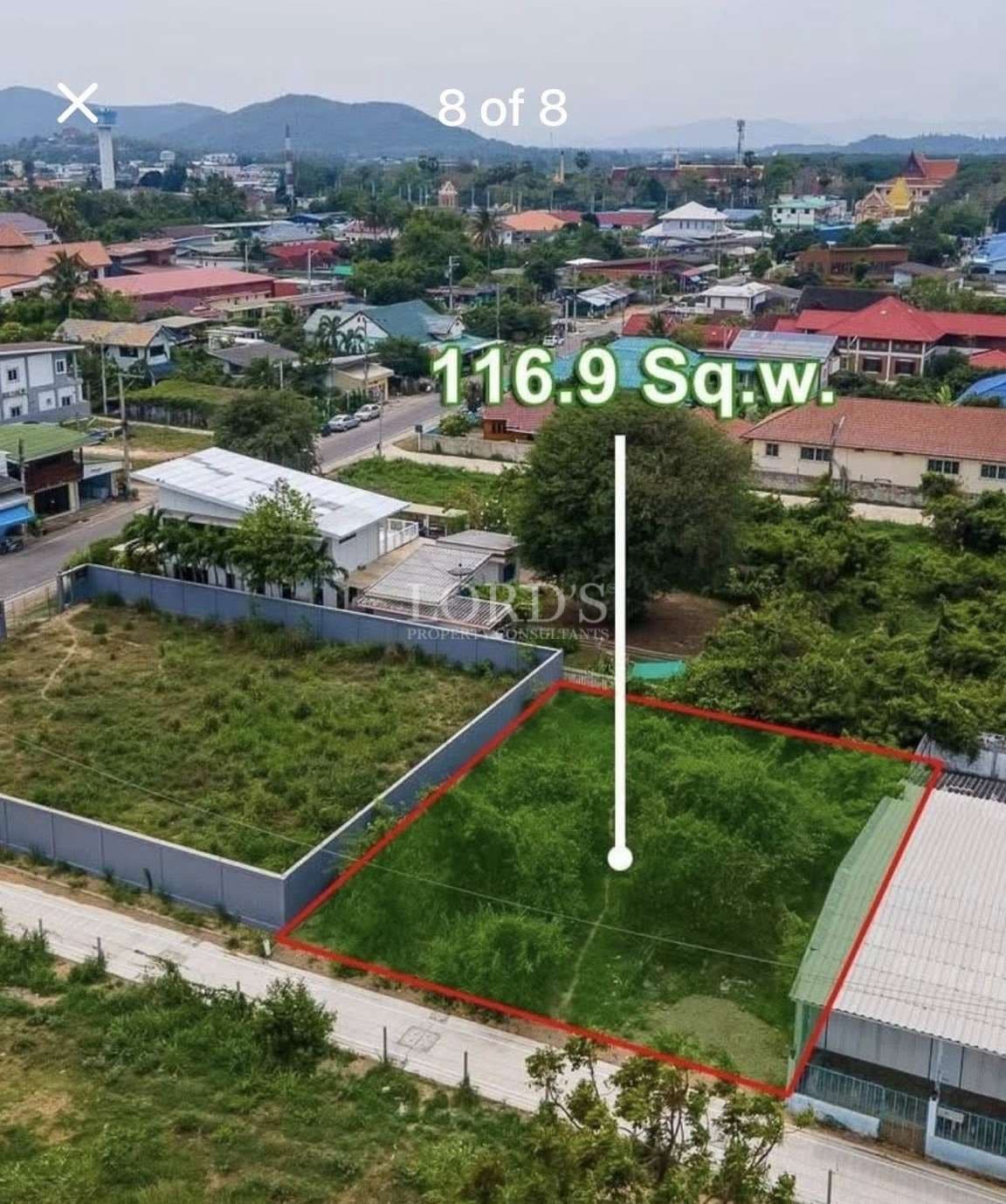 Aerial view of a 116.9 square wah residential land plot outlined in red within an urban neighborhood.