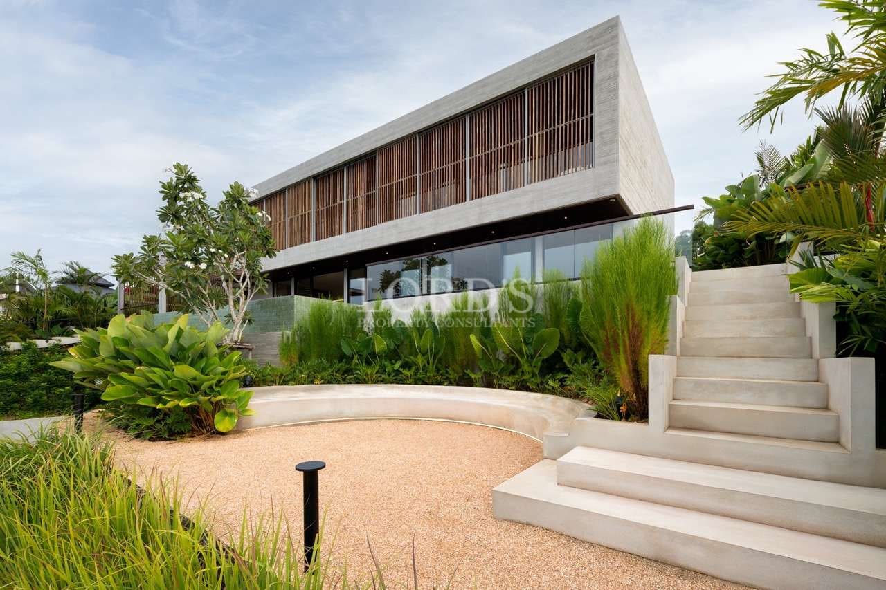 Modern house with lush landscaping.