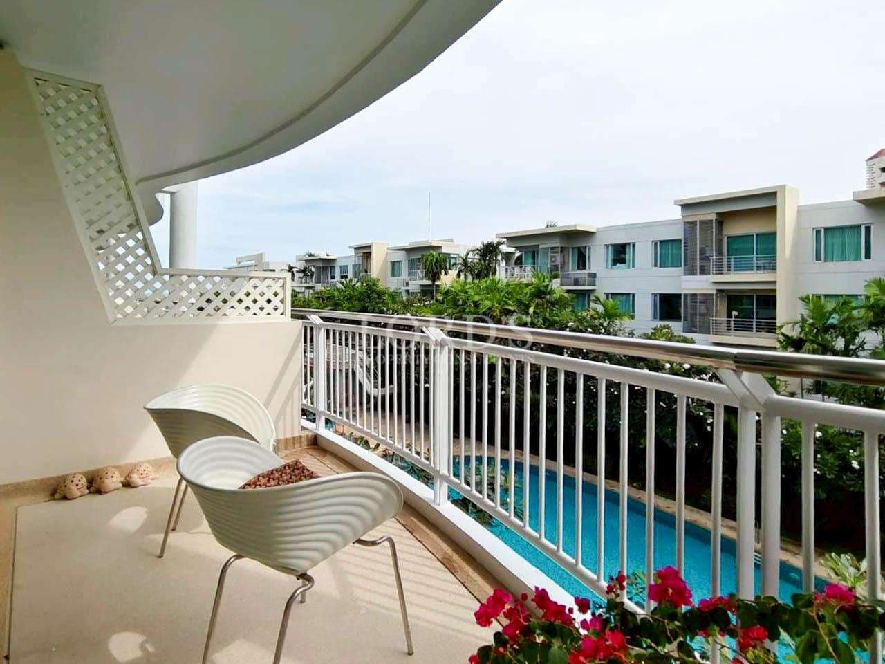 Balcony overlooking a serene pool.