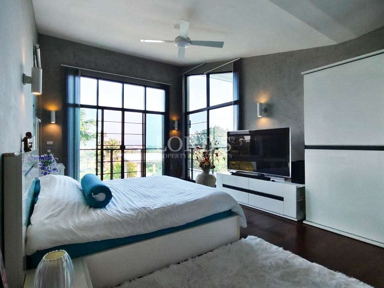 Modern bedroom with large windows