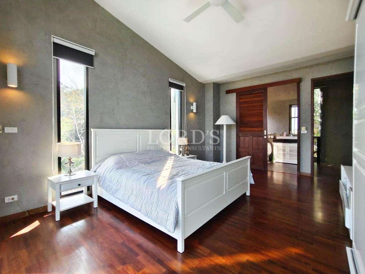 Modern bedroom with wooden flooring