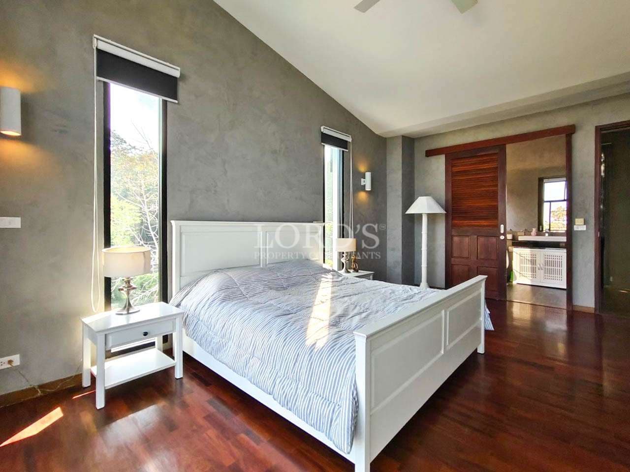 Modern bedroom with wooden flooring