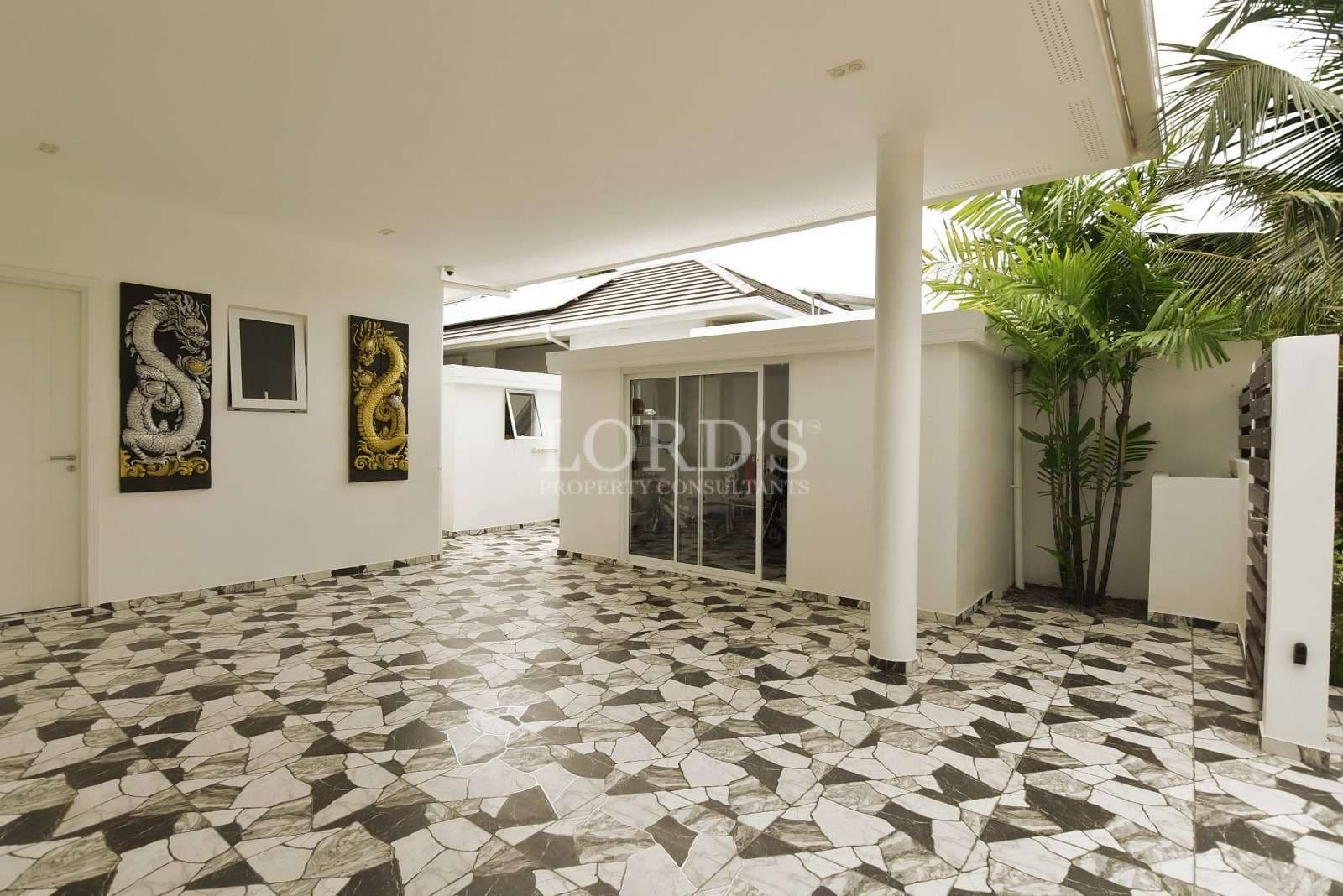 Modern patio with decorative tiles.