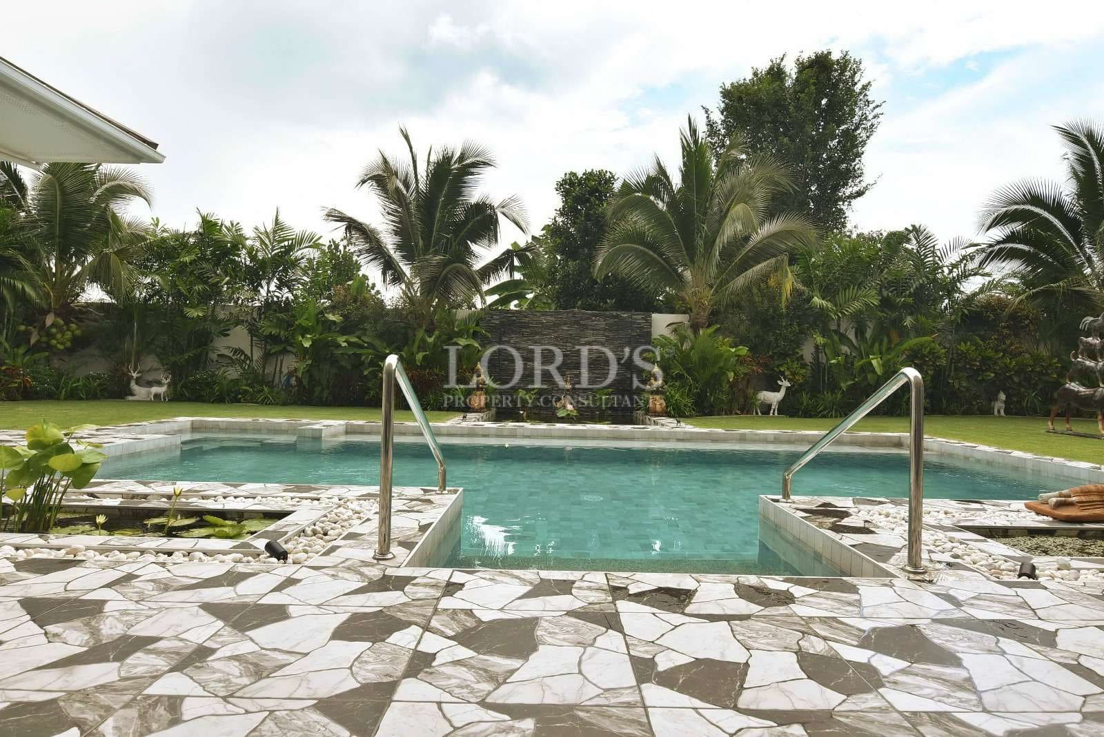 Serene pool surrounded by lush greenery
