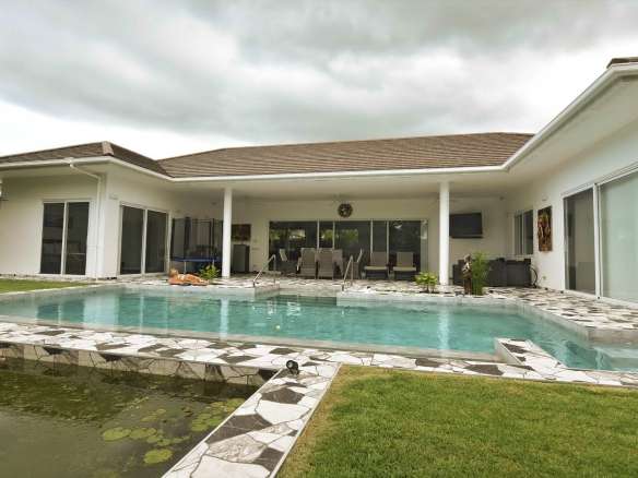 Modern villa with pool and greenery