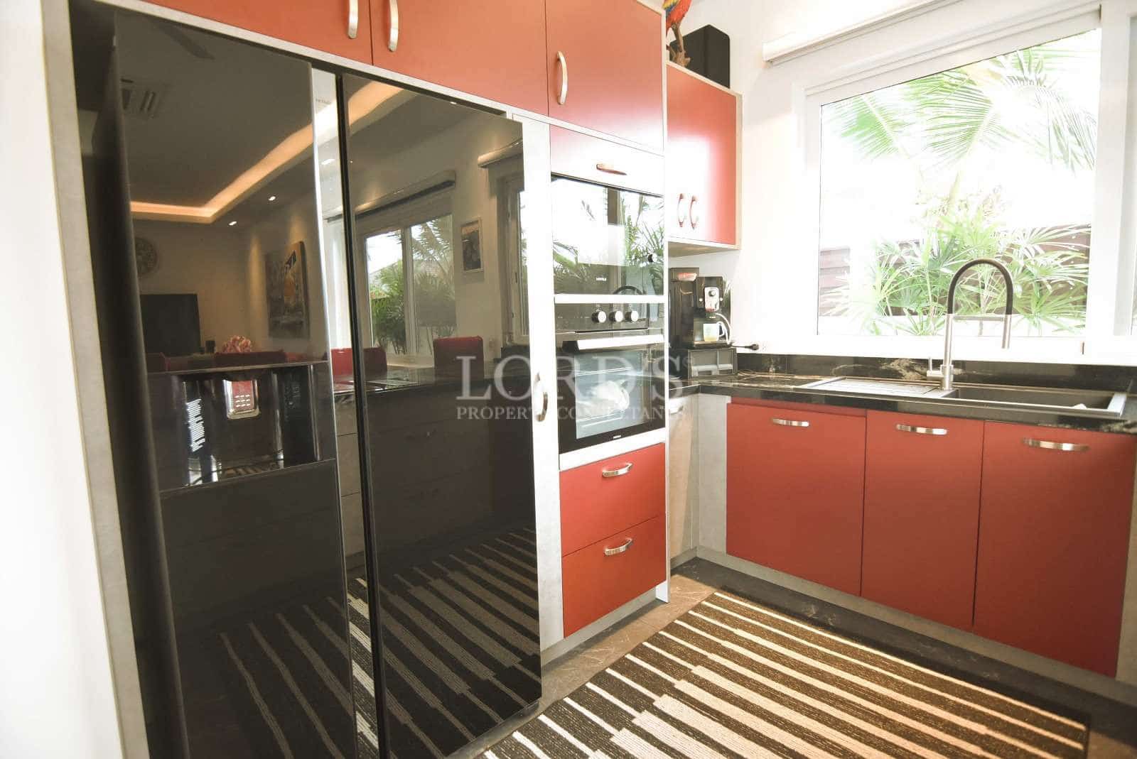Modern kitchen with red cabinets.