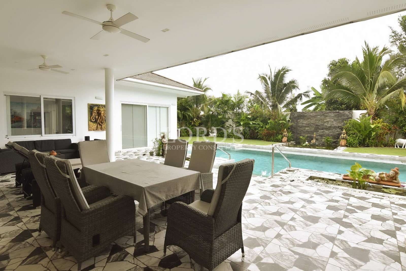 Modern patio with pool and greenery
