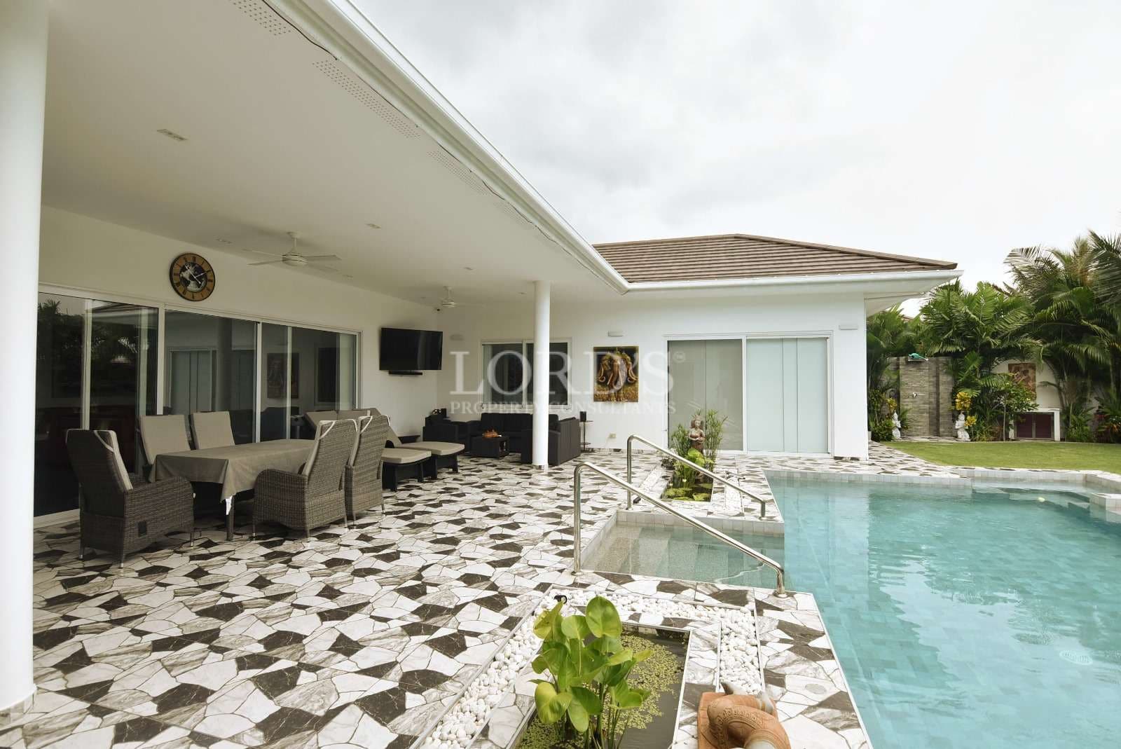 Modern patio with pool and greenery