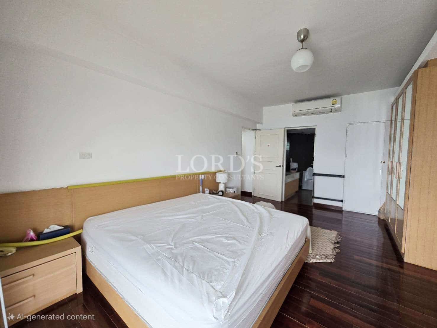 Minimalist bedroom with wooden bed frame, built-in wardrobe, and dark wood flooring.