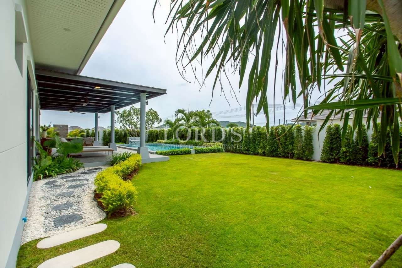 Lush green lawn with modern patio