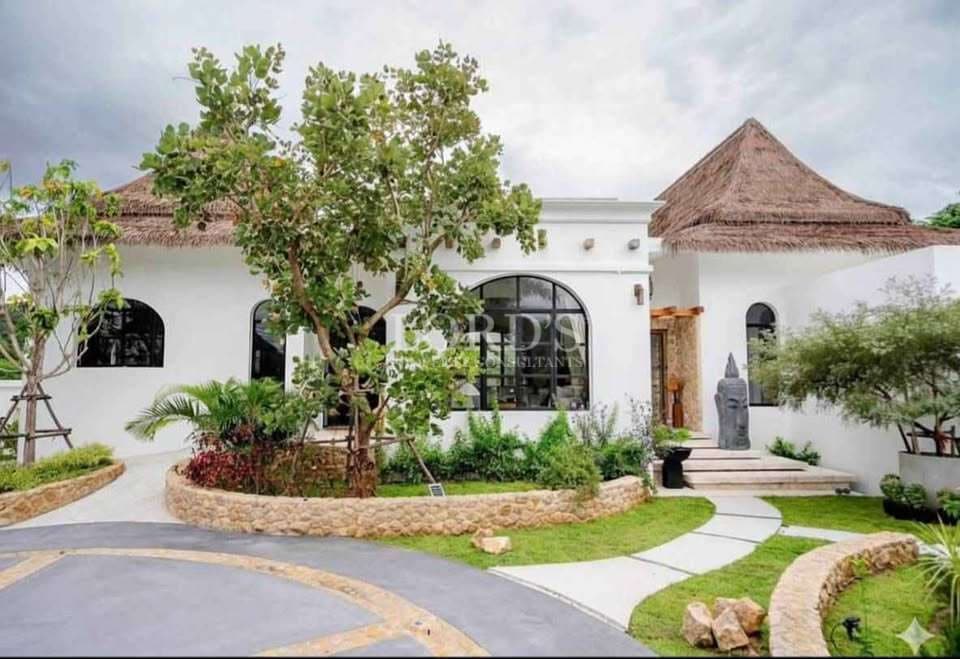 Modern villa with lush landscaping.