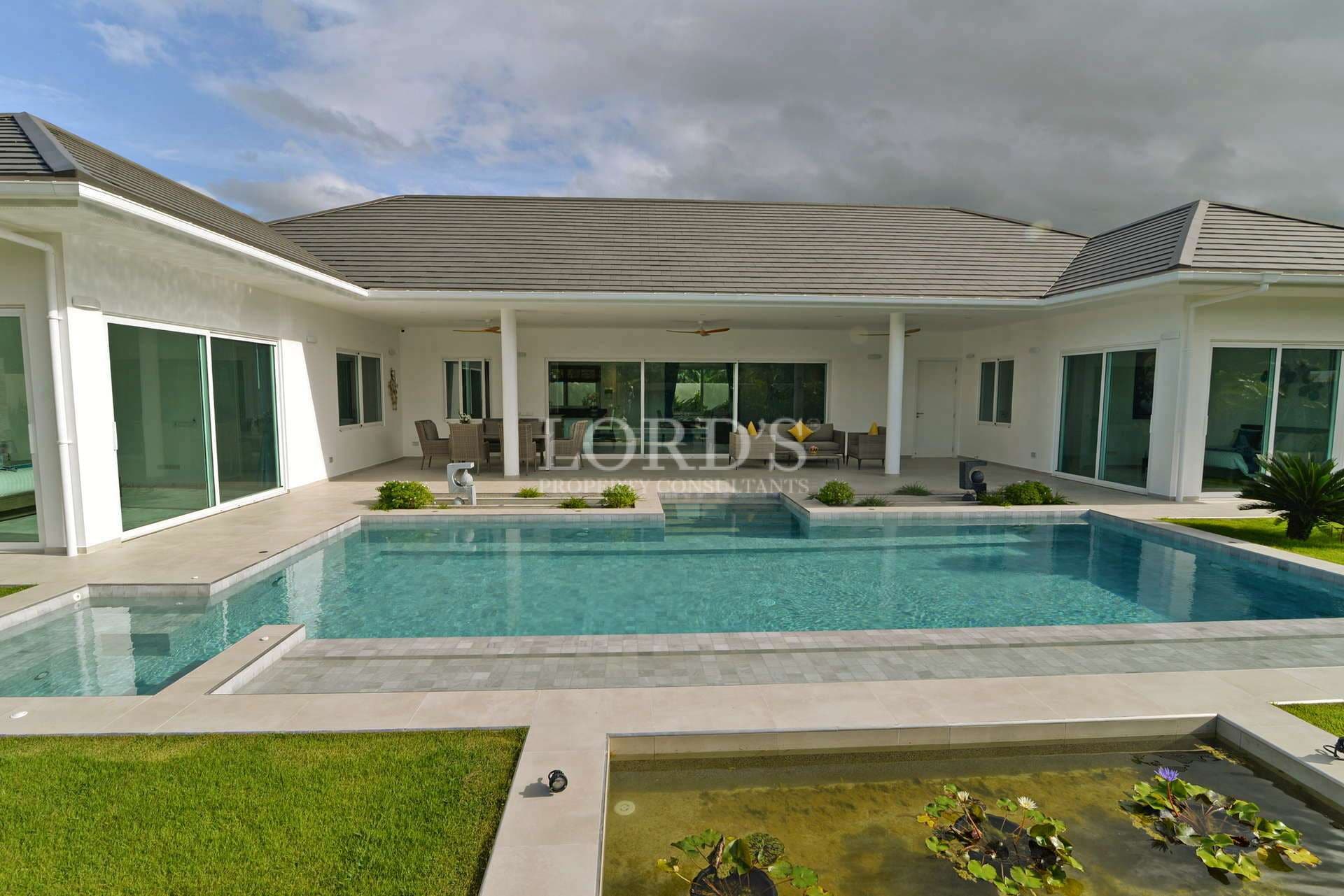 Modern single-story villa with a private swimming pool, covered terrace, and landscaped garden.