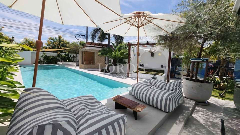 Relaxing poolside with striped loungers