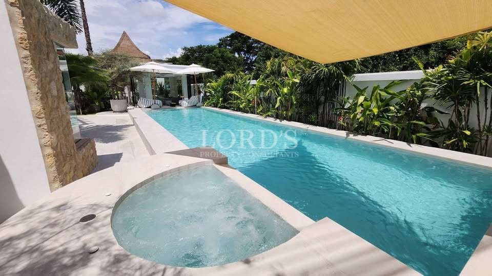 Modern poolside with lush greenery