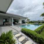 Private swimming pool with covered patio, outdoor dining area, and landscaped garden.