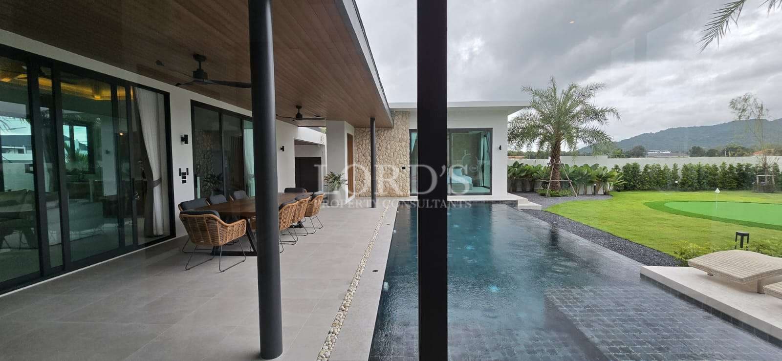Modern villa with pool and greenery