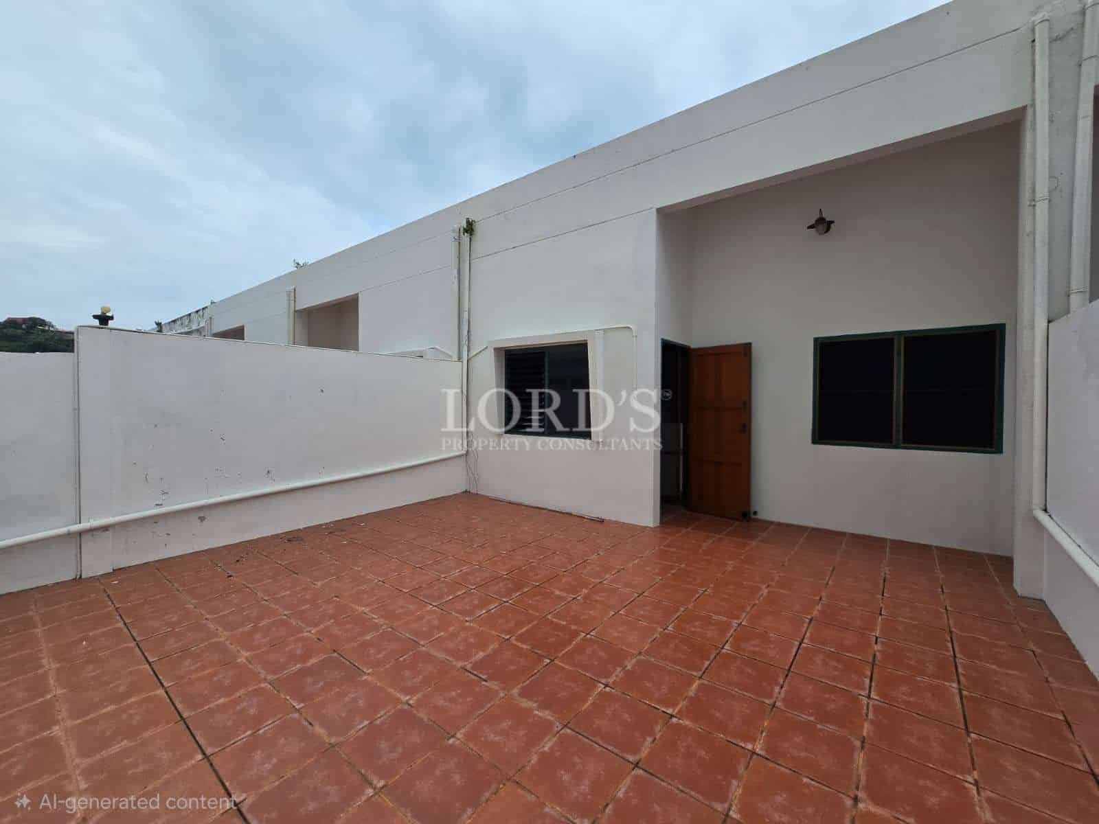 Private rooftop terrace with tiled flooring, high boundary walls, and direct access door in a modern residential property