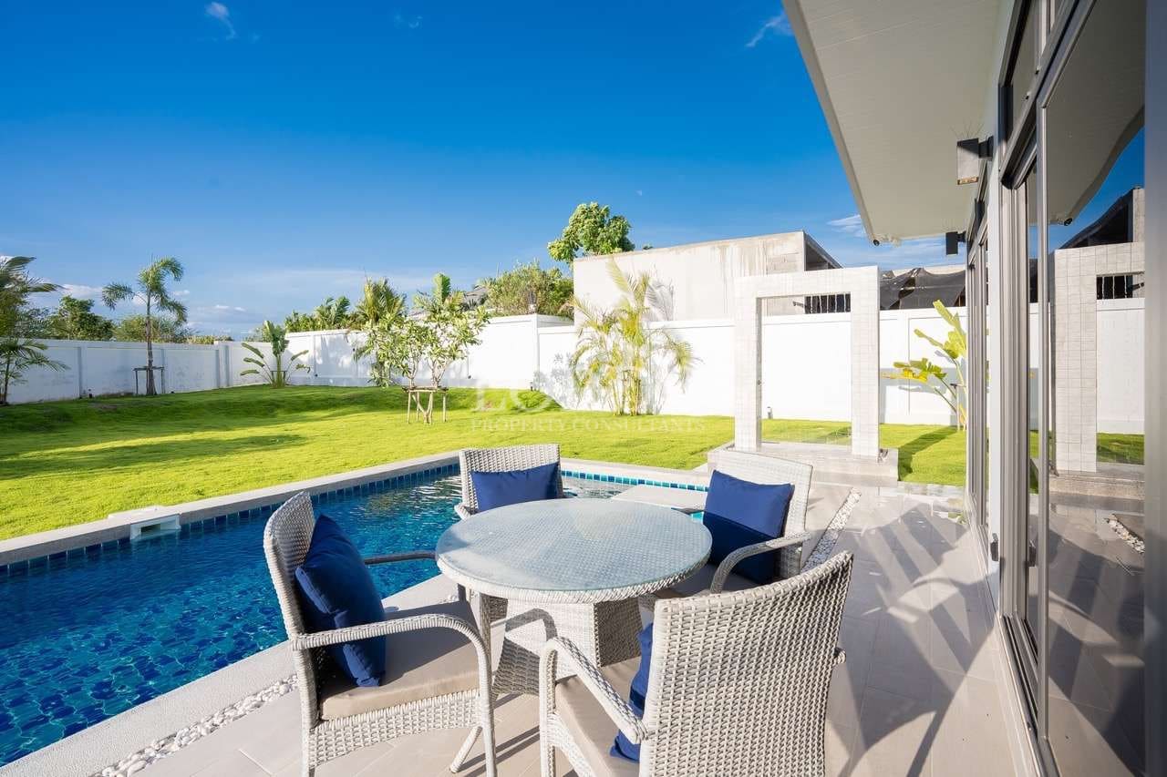 Poolside seating in sunny backyard