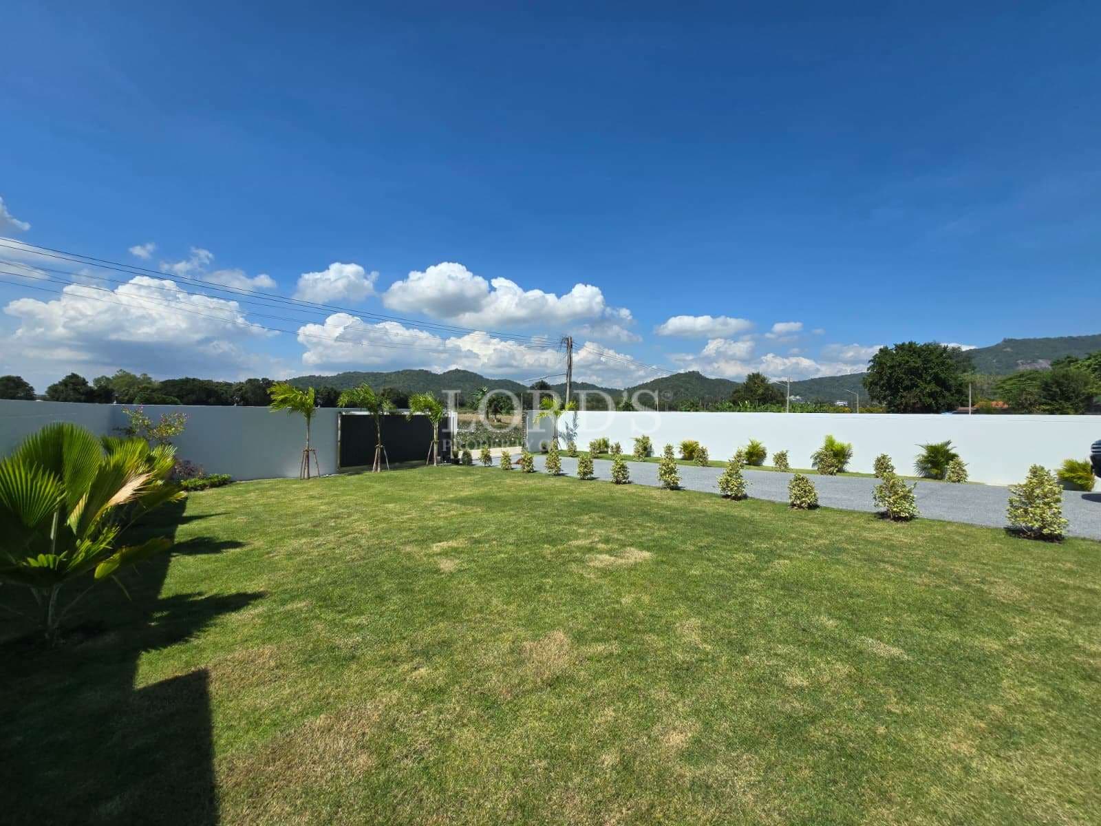Spacious green lawn with blue sky
