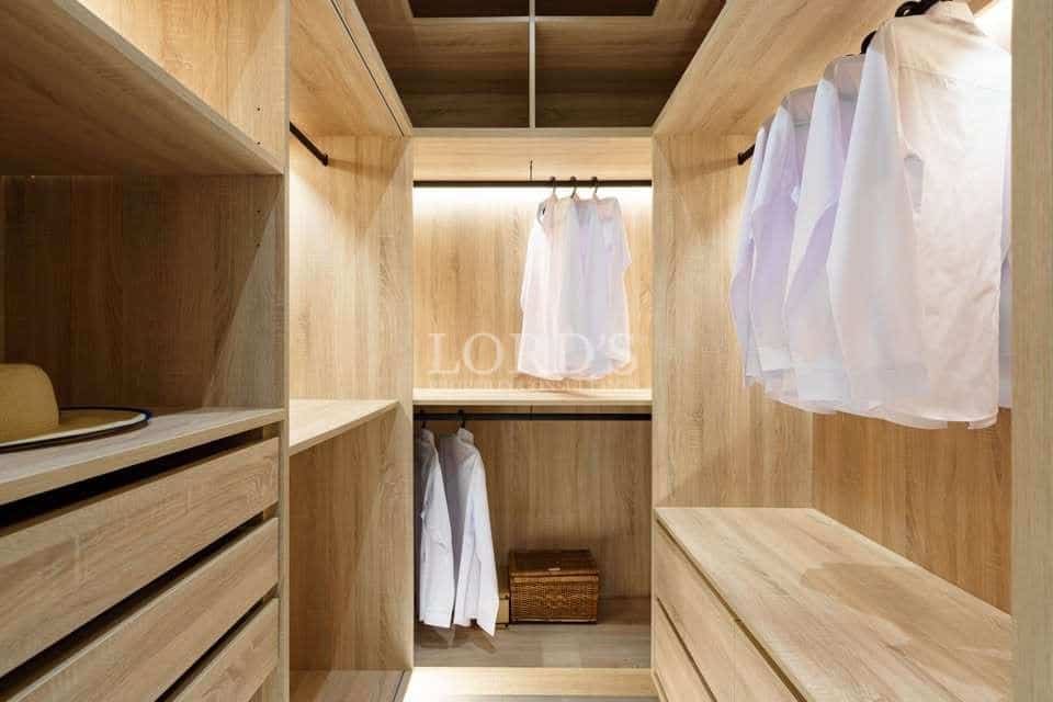 Minimalist wooden closet with clothing