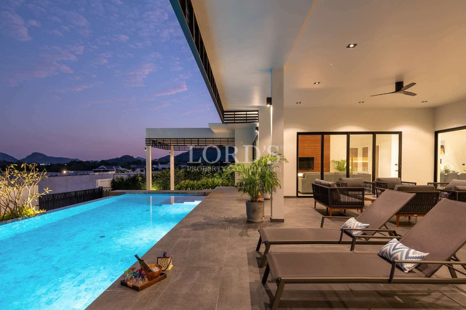 Modern villa with pool at sunset