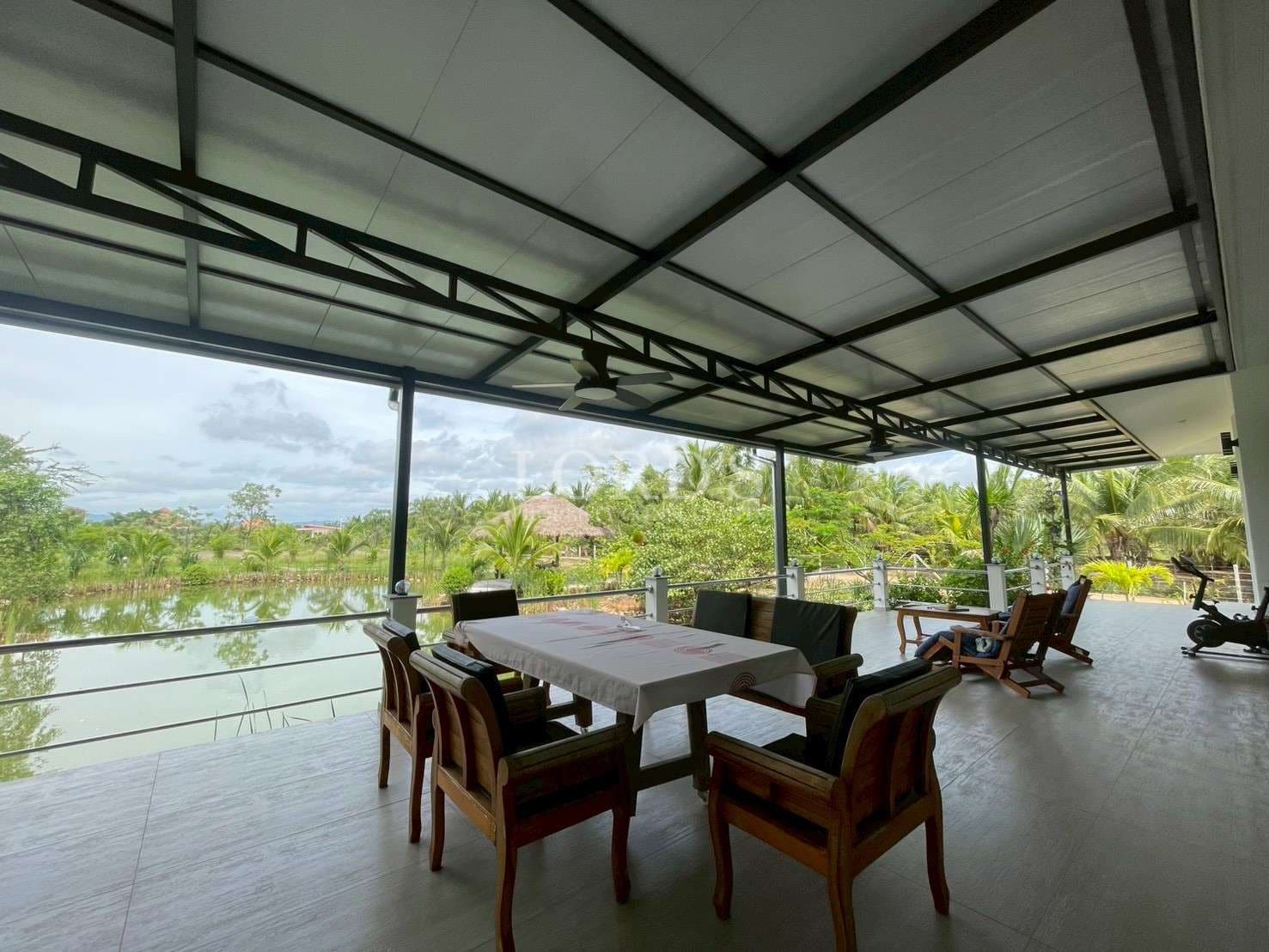 Scenic patio overlooking a tranquil lake.