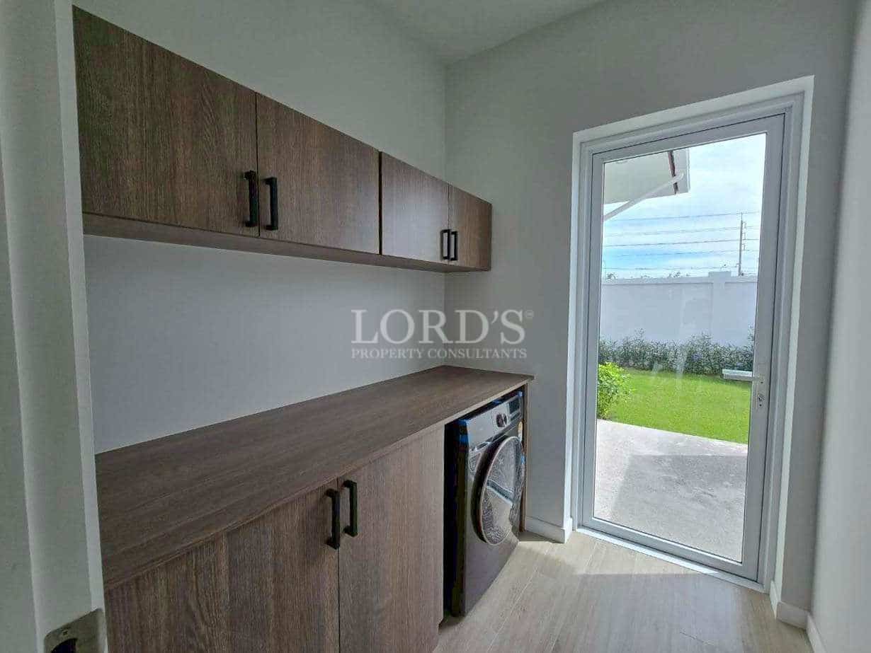 Modern laundry room with cabinets