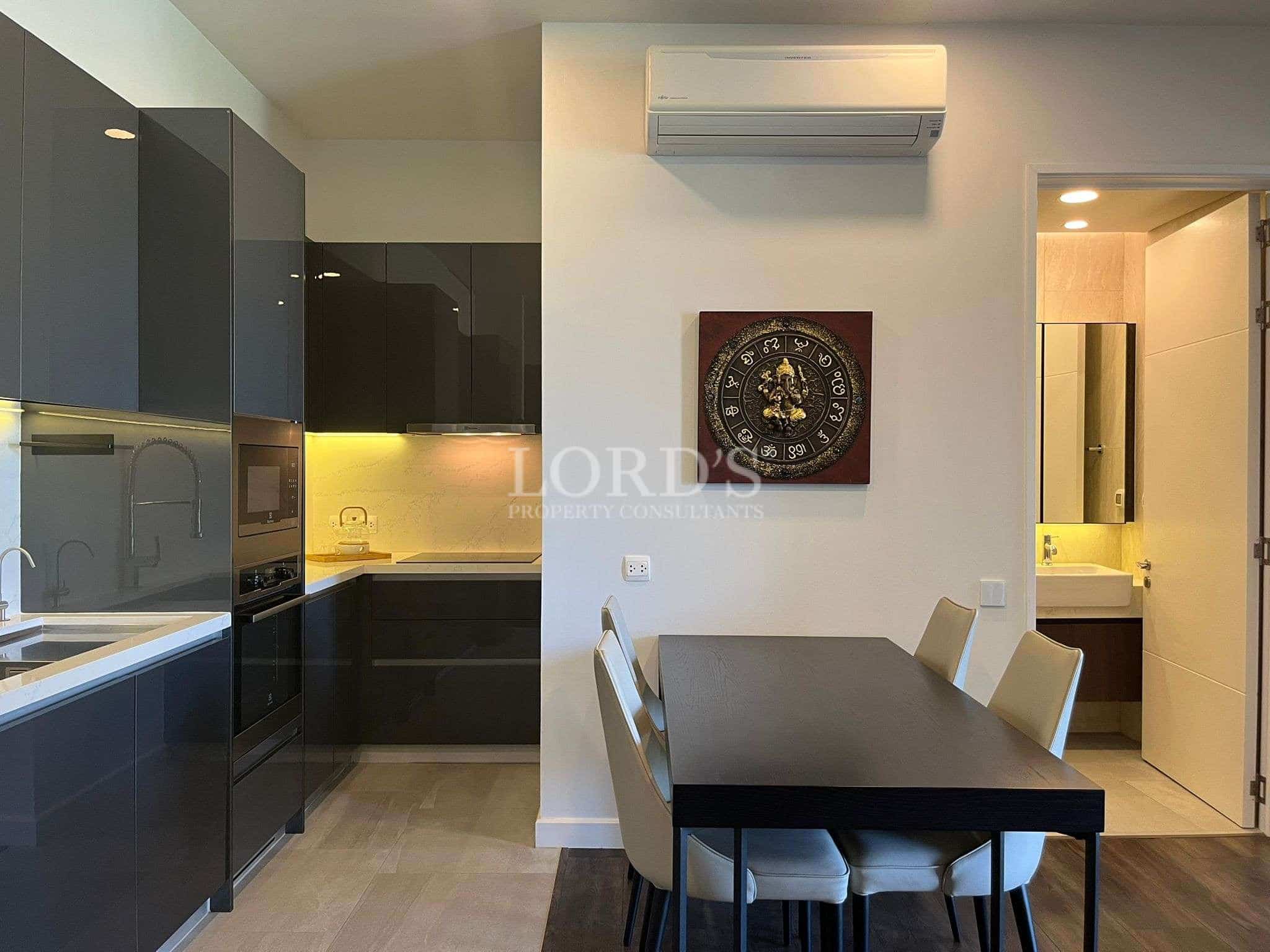 Modern open-plan kitchen and dining area with sleek cabinets and dining table